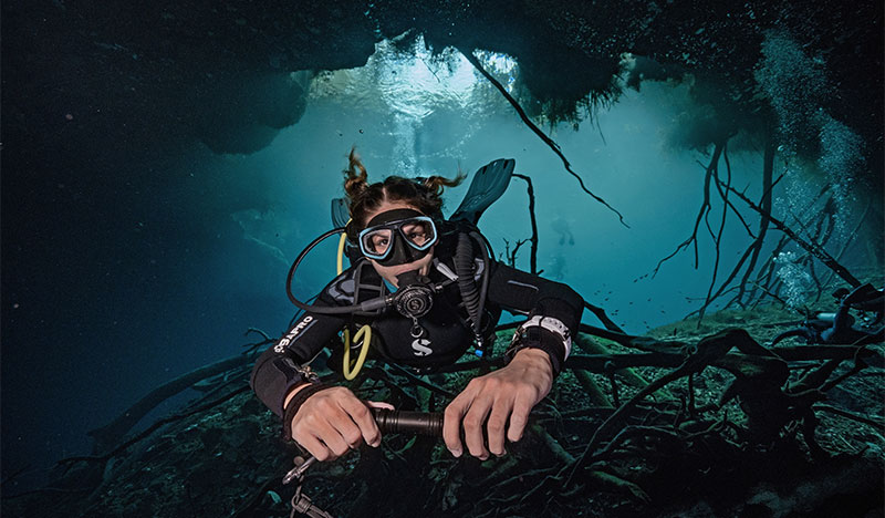 scuba diver diving in an underwater cave