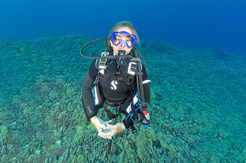 Woman diver underwater wearing the Bella BCD