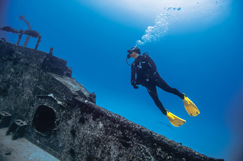 Underwater diver exploring shipwreck