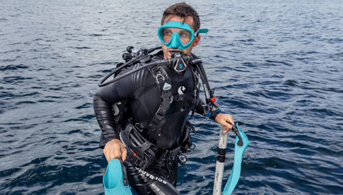 Diver in a SCUBAPRO Definition steamer coming out of the water