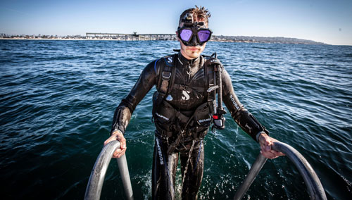 Diver wearing the SCUBAPRO Definition steamer climbing out of the water