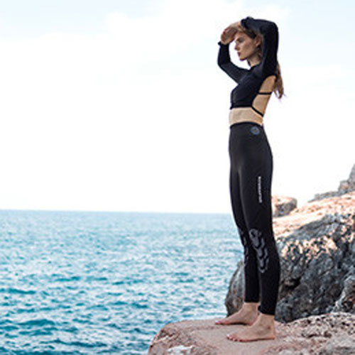 Woman wearing Everflex YULEX Pants enjoying the ocean view