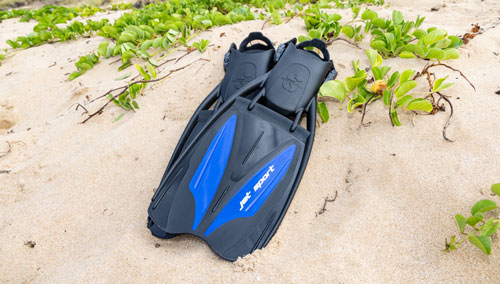 SCUBAPRO Jet Sport open heel fins laying on a sandy beach