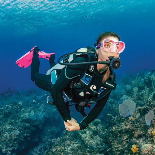 Woman diver underwater in Grand Cayman wearing SCUBAPRO gear