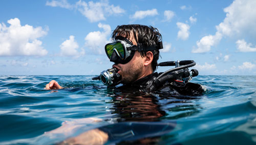 Diver with head above water wearing SCUBAPRO gear 