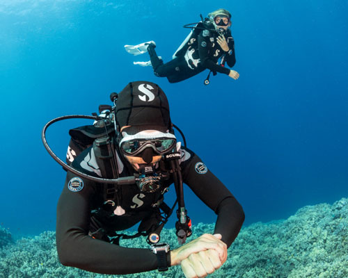 Two underwater divers wearing SCUBAPRO gear