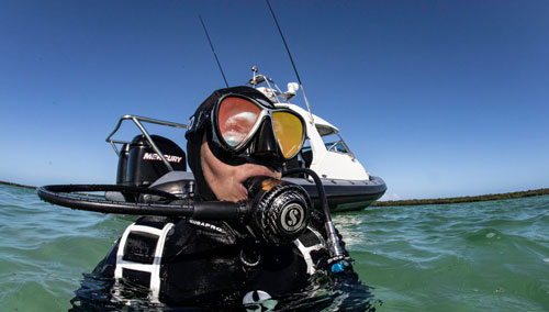 Diver with head above water wearing SCUBAPRO gear 