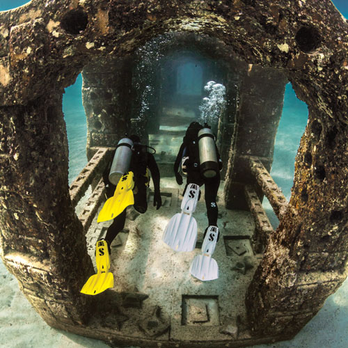 Two divers in Seawing Nova Fins exploring an underwater structure