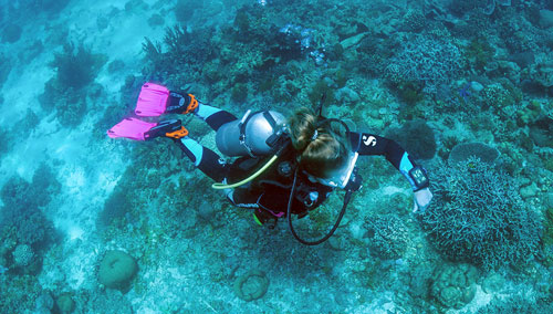 Woman diver wearing SCUBAPRO gear exploring the ocean floor