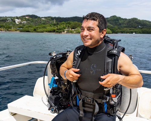 Diver in SCUBAPRO divewear sitting on a boat