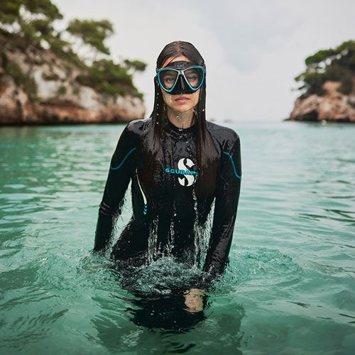 Woman standing in water wearing the SCUBAPRO Sport Women's 0.5mm Steamer